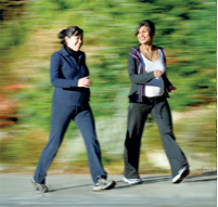 two pregnant women walking
